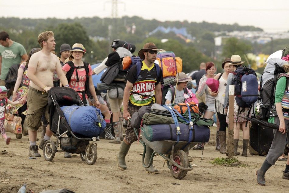 Festival goers leave Worthy Farm and the Glastonbury Festival in Somerset June 27, 2011.