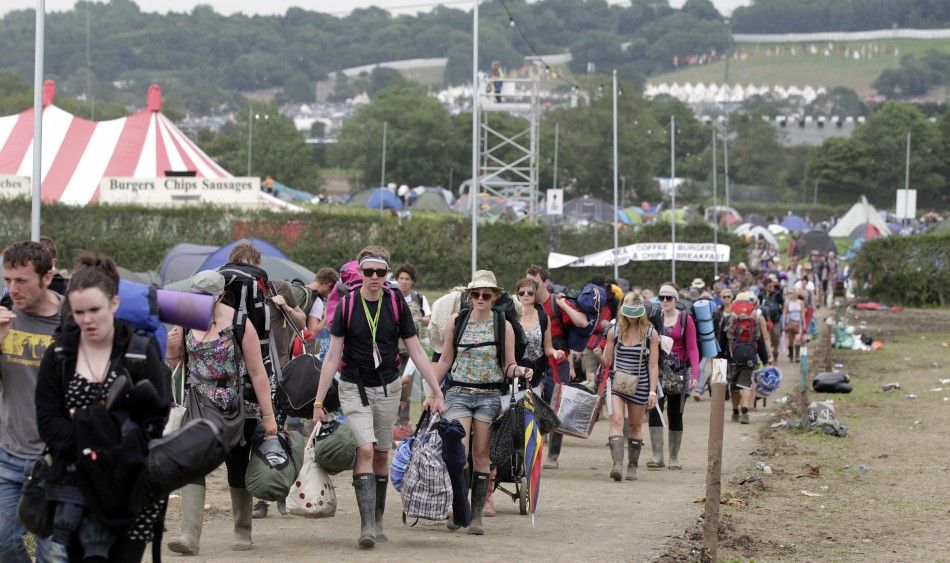 Festival goers leave Worthy Farm and the Glastonbury Festival in Somerset June 27, 2011.