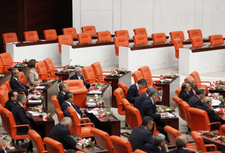 Members of far-right MHP sit next to the empty seats of the independent lawmakers supported by pro-Kurdish BDP during swearing-in ceremony in Ankara