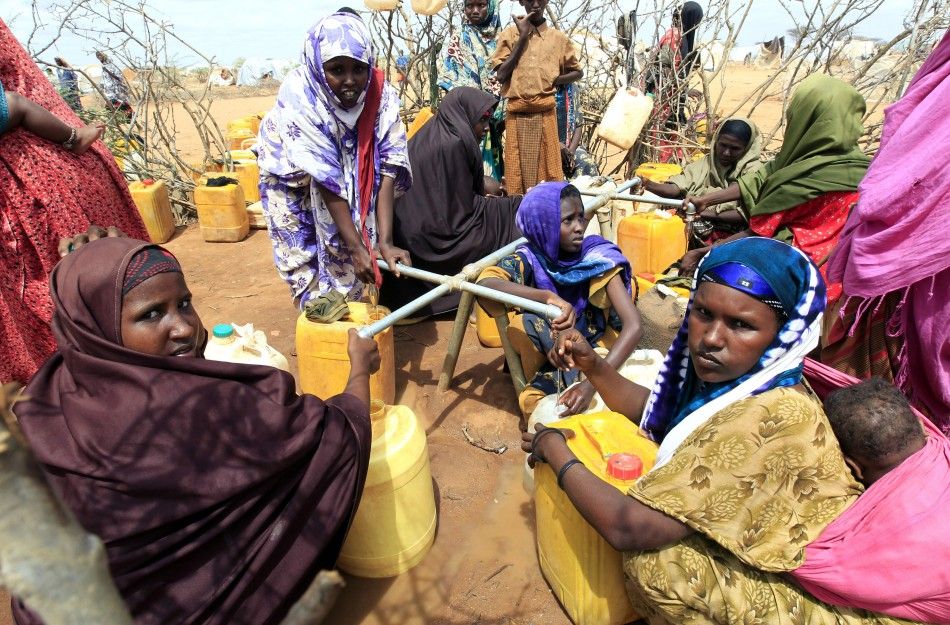 Somali refugees who recently arrived at Dagahaley camp collect water from a tap, in Dadaab