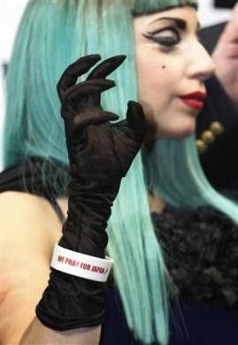 Lady Gaga, wearing an arm band with the words quotWe Pray for Japanquot, attends a news conference in Tokyo June 23, 2011.