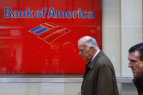 Pedestrians walk past a Bank of America sign on the street in New York