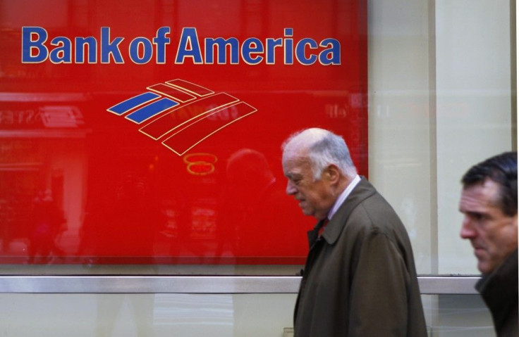 Pedestrians walk past a Bank of America sign on the street in New York