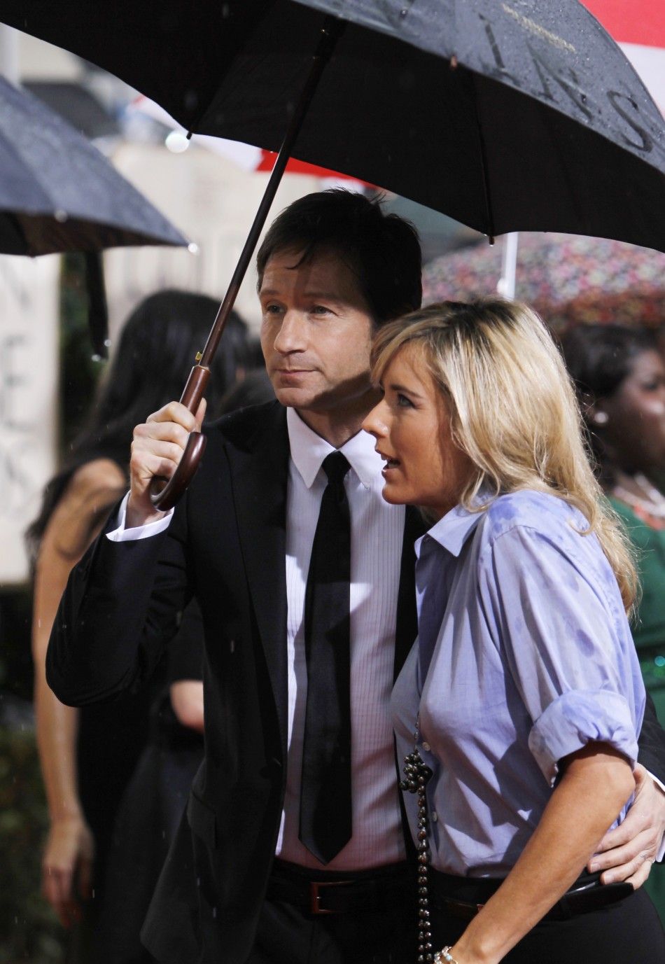 Actress Tea Leoni R and husband David Duchovny arrive at the 67th annual Golden Globe Awards in Beverly Hills, California January 17, 2010.