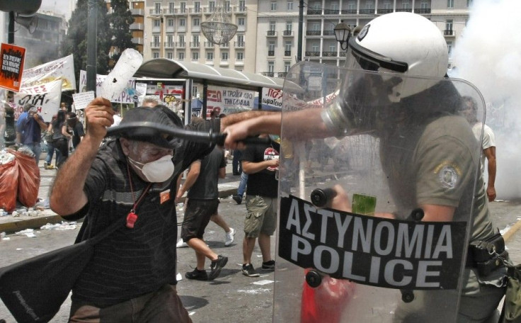 A riot policeman clashes with a demonstrator during a protest in Athens&#039; Syntagma square
