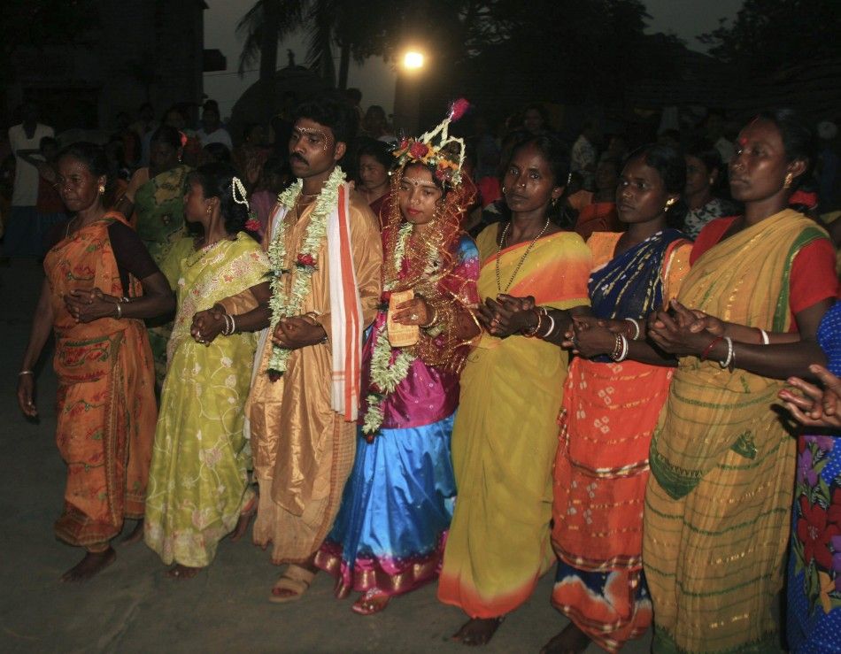 Newly married Santhal tribe couple celebrate during a marriage ceremony at Palla Road