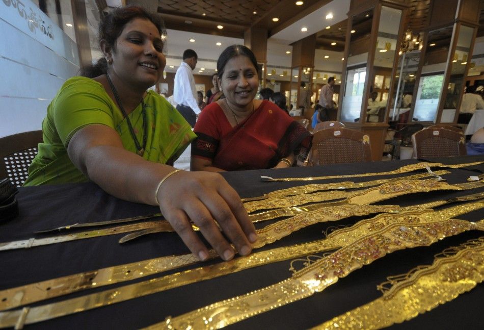 A woman checks a gold waist belt inside a jewellery shop on the occasion of Akshaya Tritiya festival in Hyderabad
