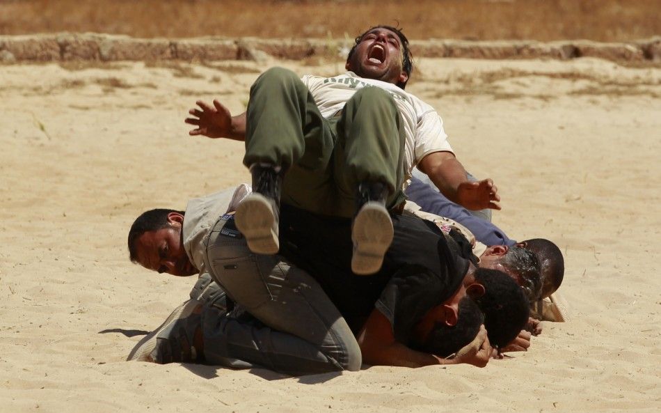 Rebel fighters demonstrate their skills during their graduation ceremony in Benghazi