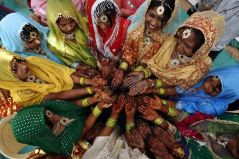 Muslim brides show their hands decorated with henna paste as they wait for the start of a mass marriage ceremony in the western Indian city of Ahmedabad March 6, 2011