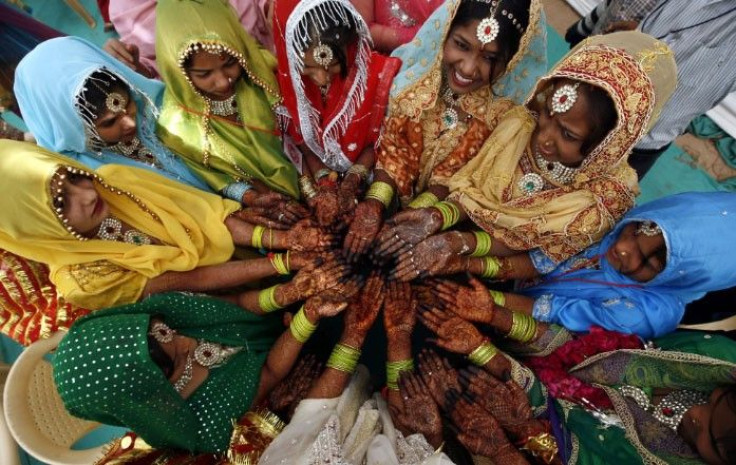 Muslim brides show their hands decorated with henna paste as they wait for the start of a mass marriage ceremony in the western Indian city of Ahmedabad March 6, 2011