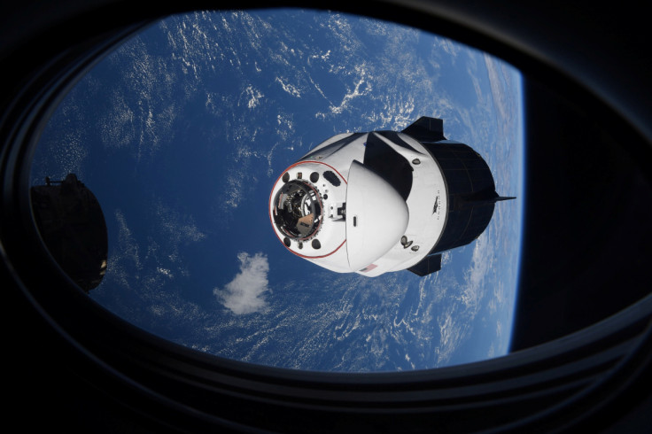 The SpaceX Crew Dragon capsule Endeavor, carrying four astronauts, approaches the International Space Station orbiting the Earth