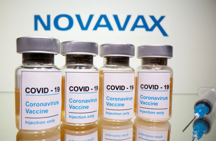 Vials and medical syringe are seen in front of Novavax logo in this illustration