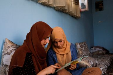 Kerishma Rasheedi, 16,  and her friend Bereshna Hesar study at her house in Kabul