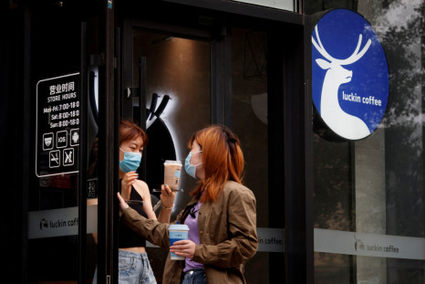 Women leave a store of the Chinese coffee house chain Luckin Coffee in Beijing