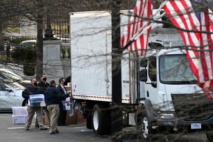 Workers move boxes from the Eisenhower Executive Office Building into a truck on the White House grounds in Washington