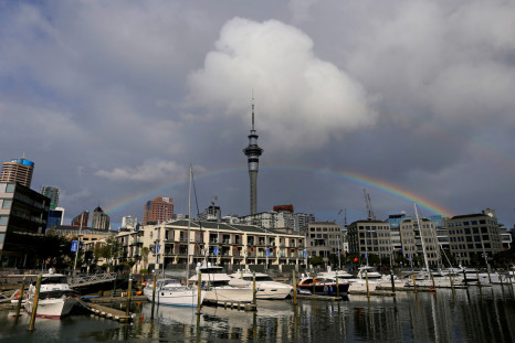 A rainbow appears on the Auckland skyline featuring Sky Tower in New Zealand