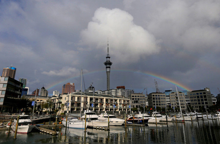 A rainbow appears on the Auckland skyline featuring Sky Tower in New Zealand