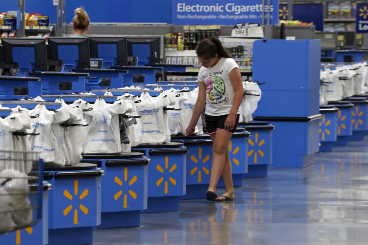 A girl walks along the checkouts at the Wal-Mart Supercenter in Springdale