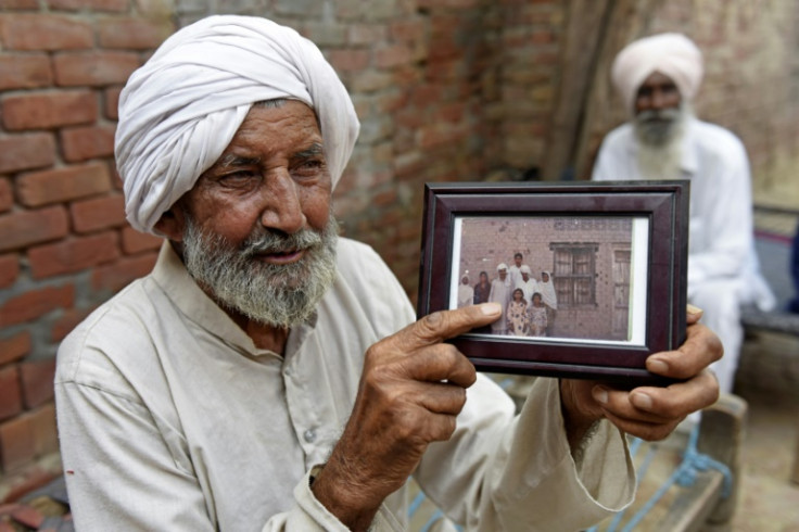 Indian Sikh labourer Sika Khan shows his elder brother Sadiq Khan's picture during an interview with AFP