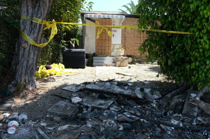 Charred debris and caution tape are seen at the home where US actor Anne Heche crashed her car last week
