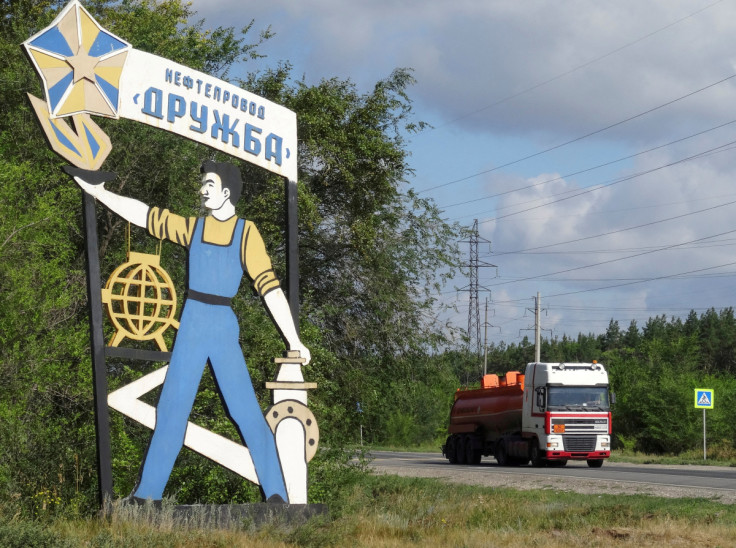 A fuel tank truck drives past a 'Druzhba oil pipeline' signboard near Samara, Russia