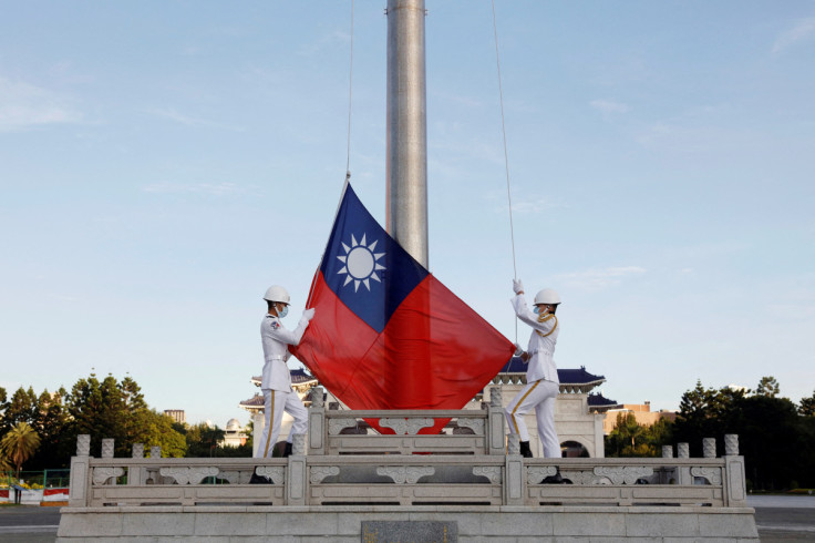 Honour guard members take part in a flag-raising ceremony in Taipei