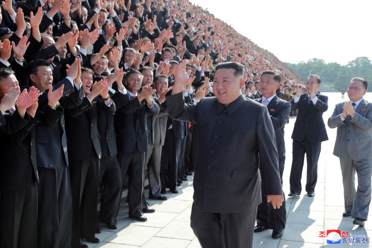 North Korea's leader Kim Jong Un greets health workers and scientists struggling with the coronavirus disease (COVID-19) pandemic during a photo session in Pyongyang