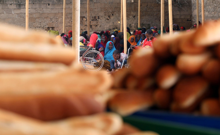 Somali displaced people wait to receive iftar charity food on the first day of the holy fasting month of Ramadan, in Mogadishu