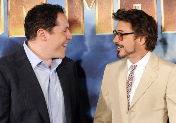 Director Jon Favreau and actor Robert Downey Jr talk while posing during a photocall for the movie Iron Man 2 in Los Angeles.