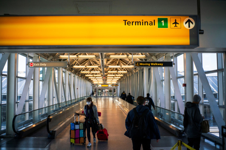 People walk around terminal one at JFK airport after the Federal Aviation Administration (FAA) temporarily halted flights arriving at New York City airports due to coronavirus disease (COVID-19) in New York