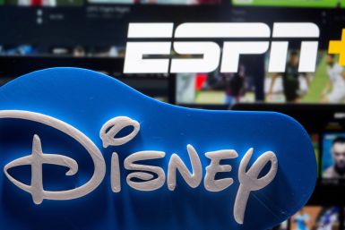 Photo illustration of a 3D-printed Disney logo seen in front of the ESPN+ logo