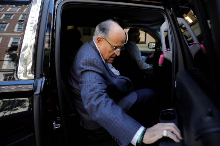 Former New York City Mayor Rudy Giuliani is seen in a vehicle outside his apartment building after his law license was suspended in Manhattan in New York City