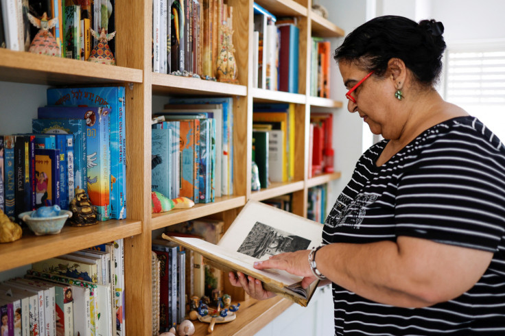 Ilana Elyassi checks a book at her home in the Kibbutz following the three-day Israel-Gaza fighting