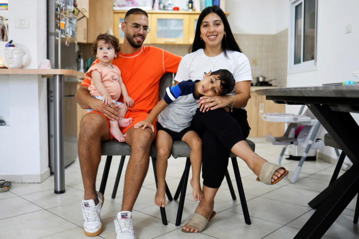 Amit, Ravit, Itay and Emanuel Shubely sit at their apartment in Ashkelon following the three-day Israel-Gaza fighting