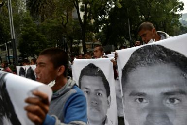 Protesters march in Mexico City in September 2020 carrying photos of the 43 students who disappeared in 2014