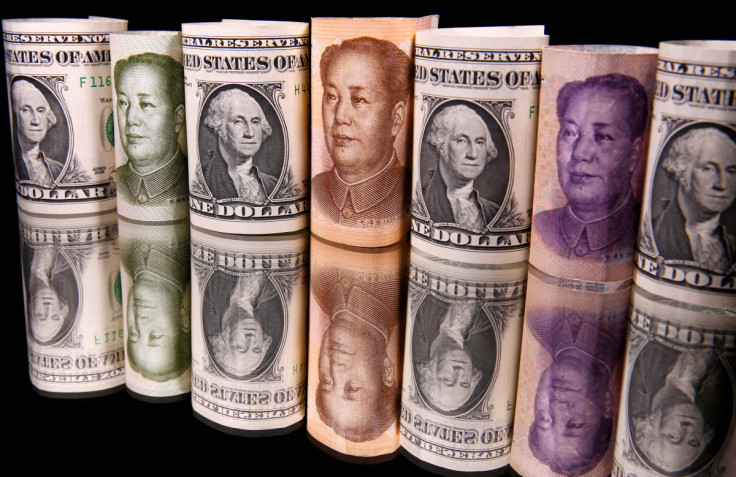 Chinese Yuan and U.S. dollar banknotes are seen in this illustration