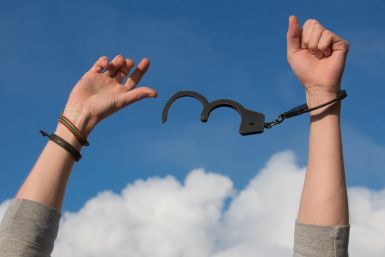 A Man Breaking Free From His Handcuffs