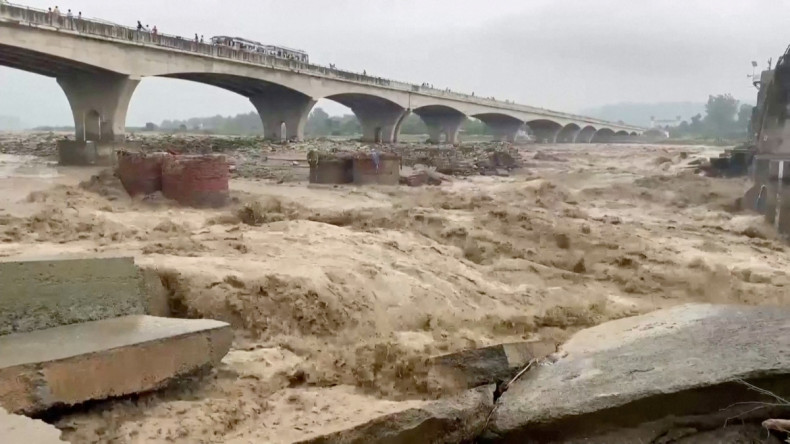 A general view of strong currents in the Chakki river following heavy rains in Kangra