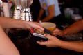 A woman pays with a credit card at a restaurant in Playa del Ingles, Maspalomas on the island of Gran Canaria