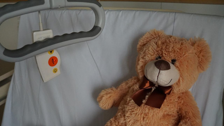 Hospital bed, teddy bear,
