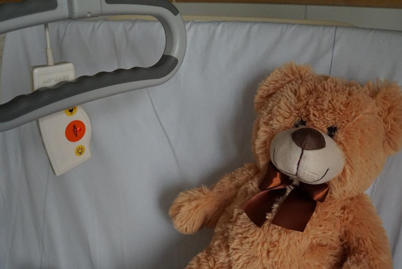 Hospital bed, teddy bear,
