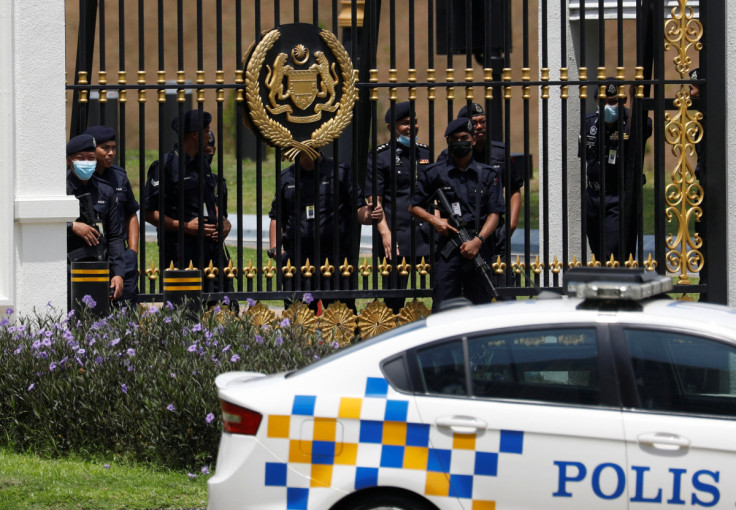 Policemen stand guard at the entrance of National Palace as the supporters of former Malaysian Prime Minister Najib Razak gather to handover a memorandum against Najib's jail sentence in Kuala Lumpur