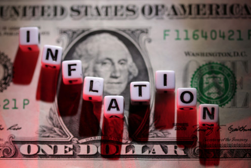 Illustration shows plastic letters arranged to read "Inflation" are placed on U.S. Dollar banknote