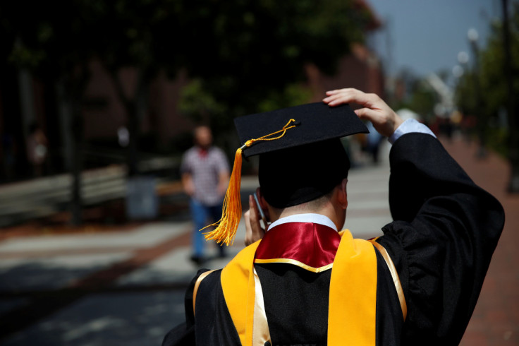 FILE PHOTO - A graduate holds their mortarboard cap after a commencement ceremony at the University of Southern California (USC) in Los Angeles, California