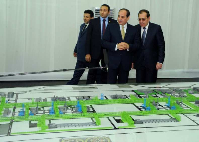 President Abdel Fattah el-Sisi inspects a model of a natural gas extraction facility