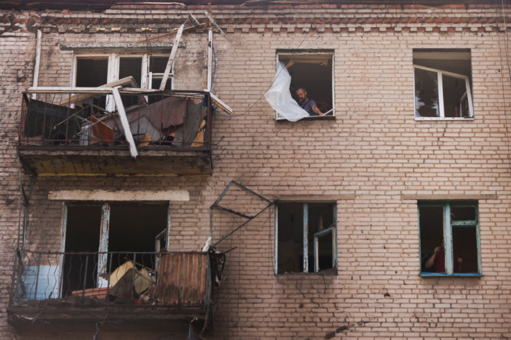 A Ukrainian man checks damage in houses following recent Russian shelling in the city of Slovyansk