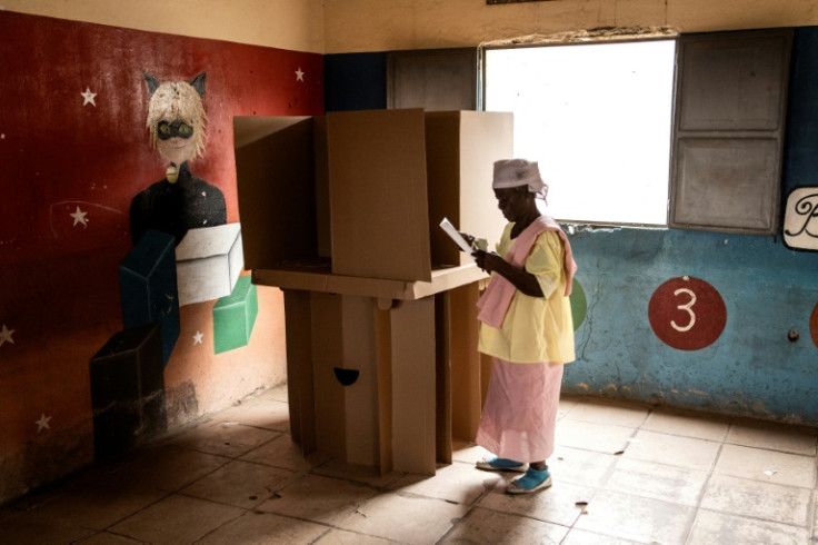 Angolans started casting ballots on August 24, 2022 in what is expected to be the most competitive vote in its democratic history, with incumbent president Joao Lourenco squaring up against charismatic opposition leader Adalberto Costa Junior. A woman fol