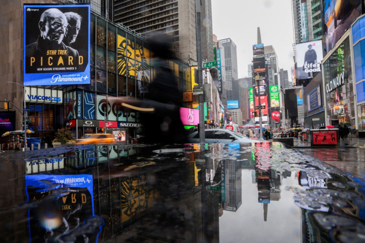 People walk around Times Square during the pass of a winter storm in New York