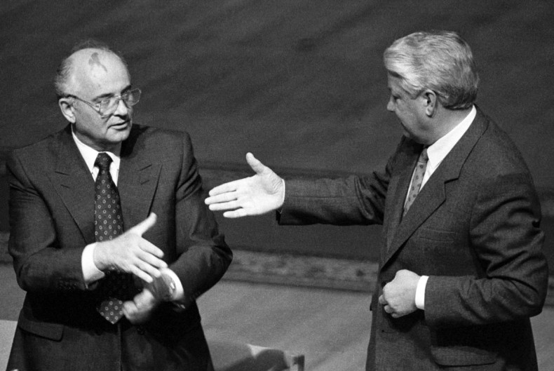 Russian President Yeltsin approaches to shake hands with Soviet President Gorbachev during Gorbachev's address to the Extraordinary meeting of the Supreme Soviet of Russian Federation in Moscow