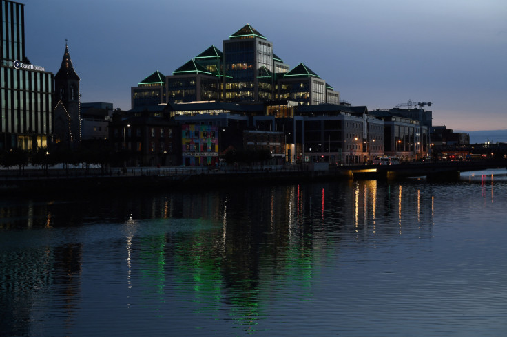 Buildings in the IFSC Irish Financial Services Centre are reflected at sunset in the river Liffey in Dublin